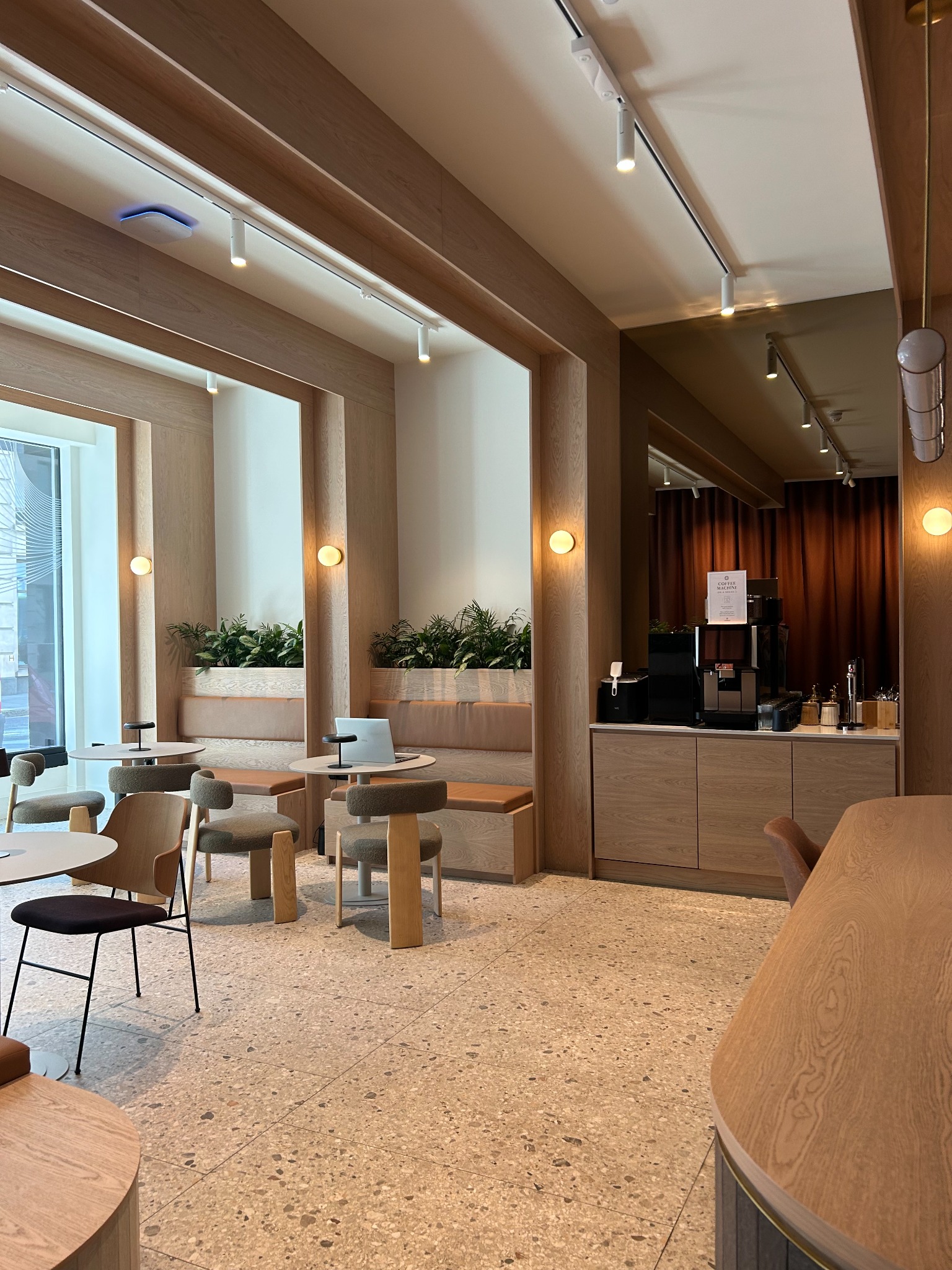 Shared workplace café with timber detailing and integrated planting