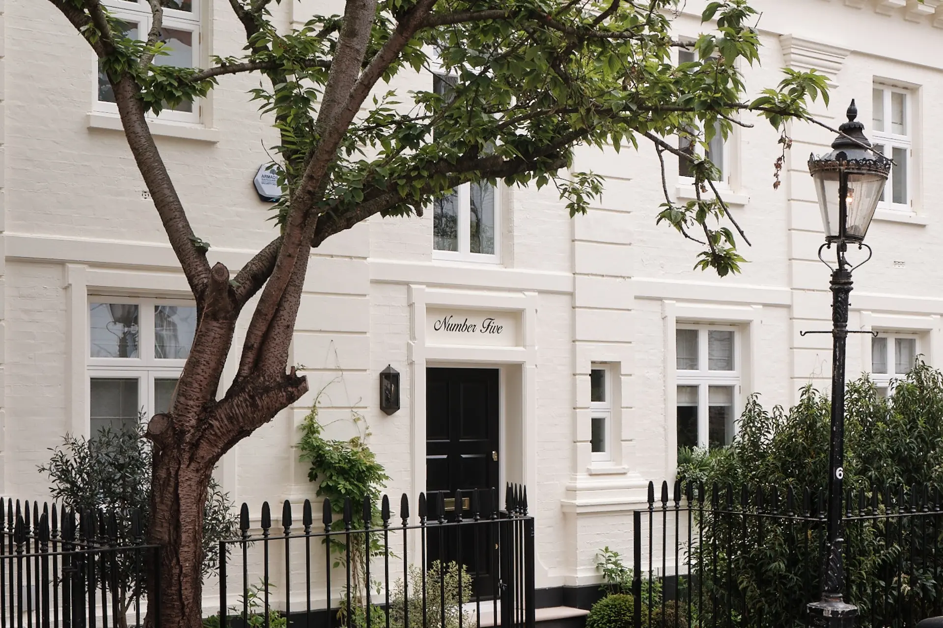 Restored white-painted townhouse entrance at Rutland Gardens in Knightsbridge