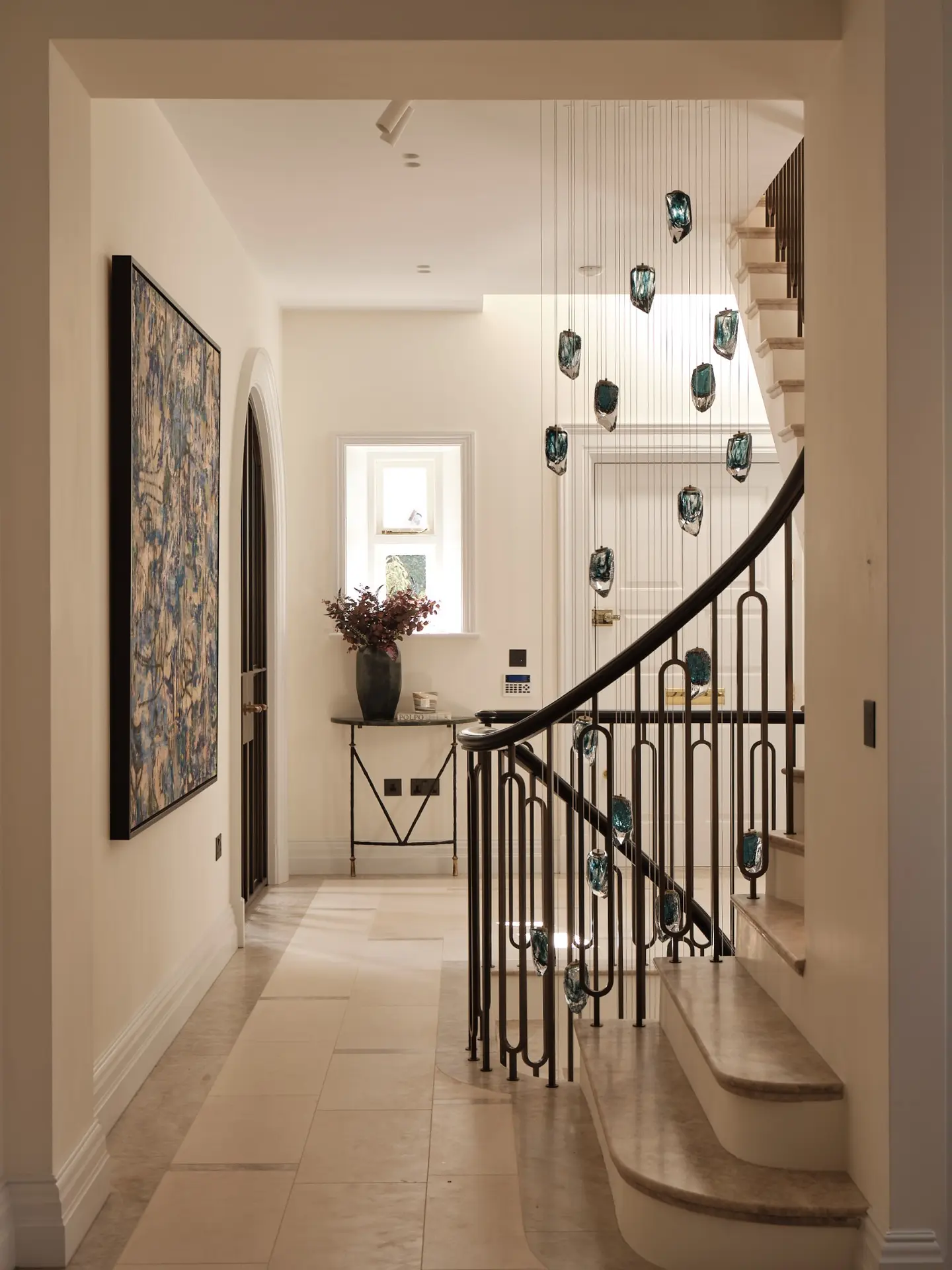 Curved staircase and bespoke pendant installation in the main hall