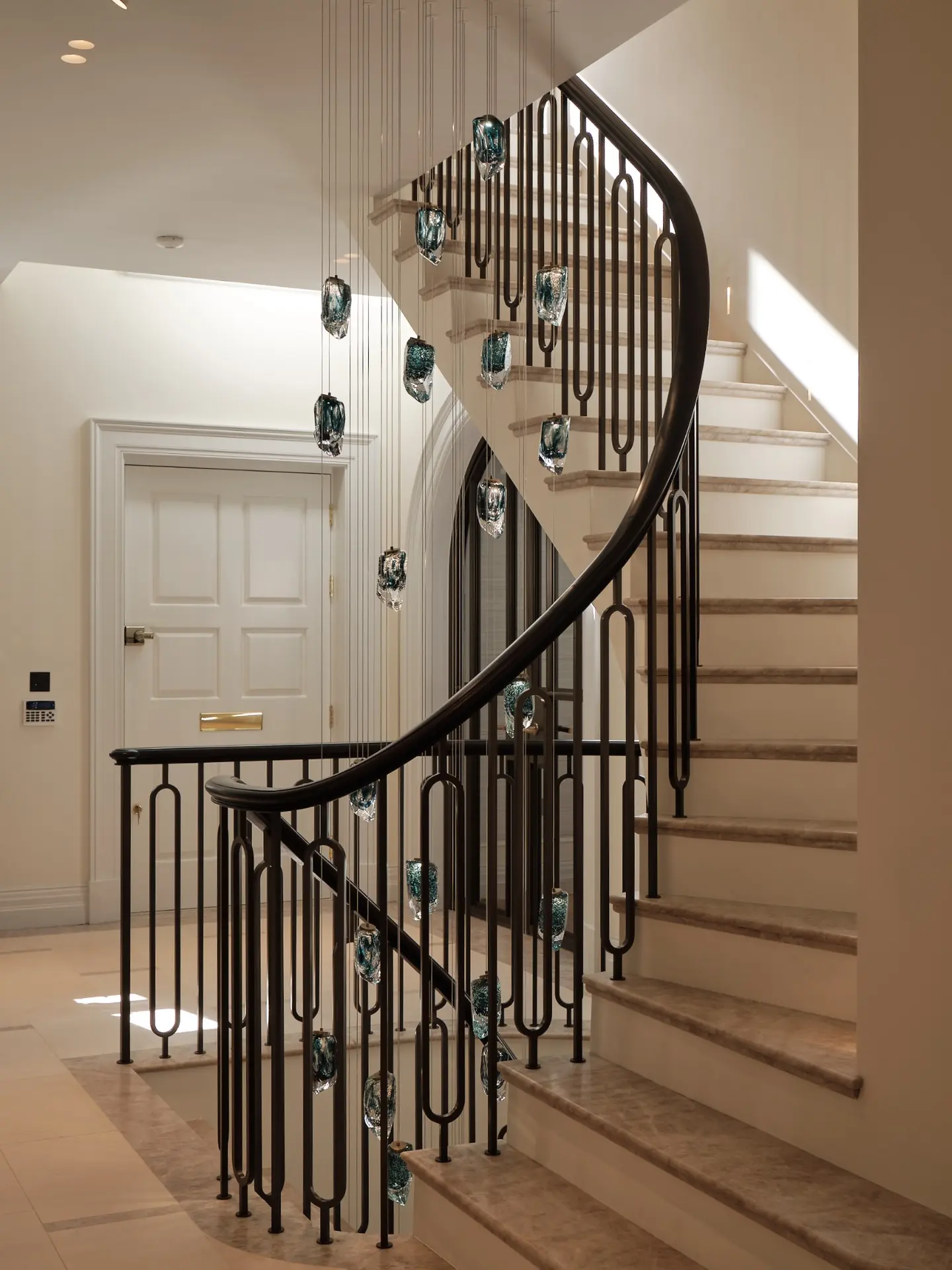 Wide view of the restored curved staircase across several levels