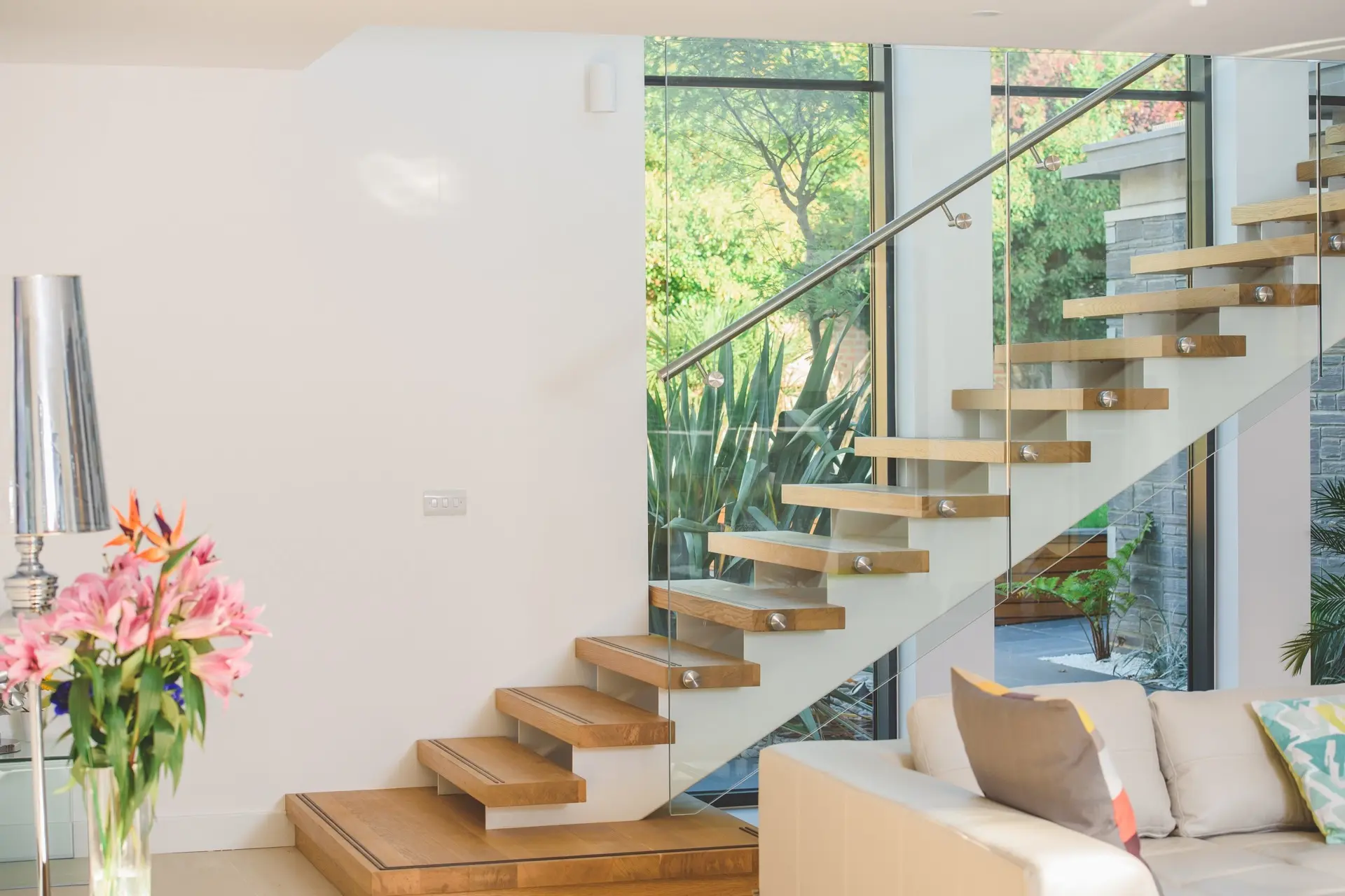 Cantilevered timber stair beside full-height glazing at St Elmo