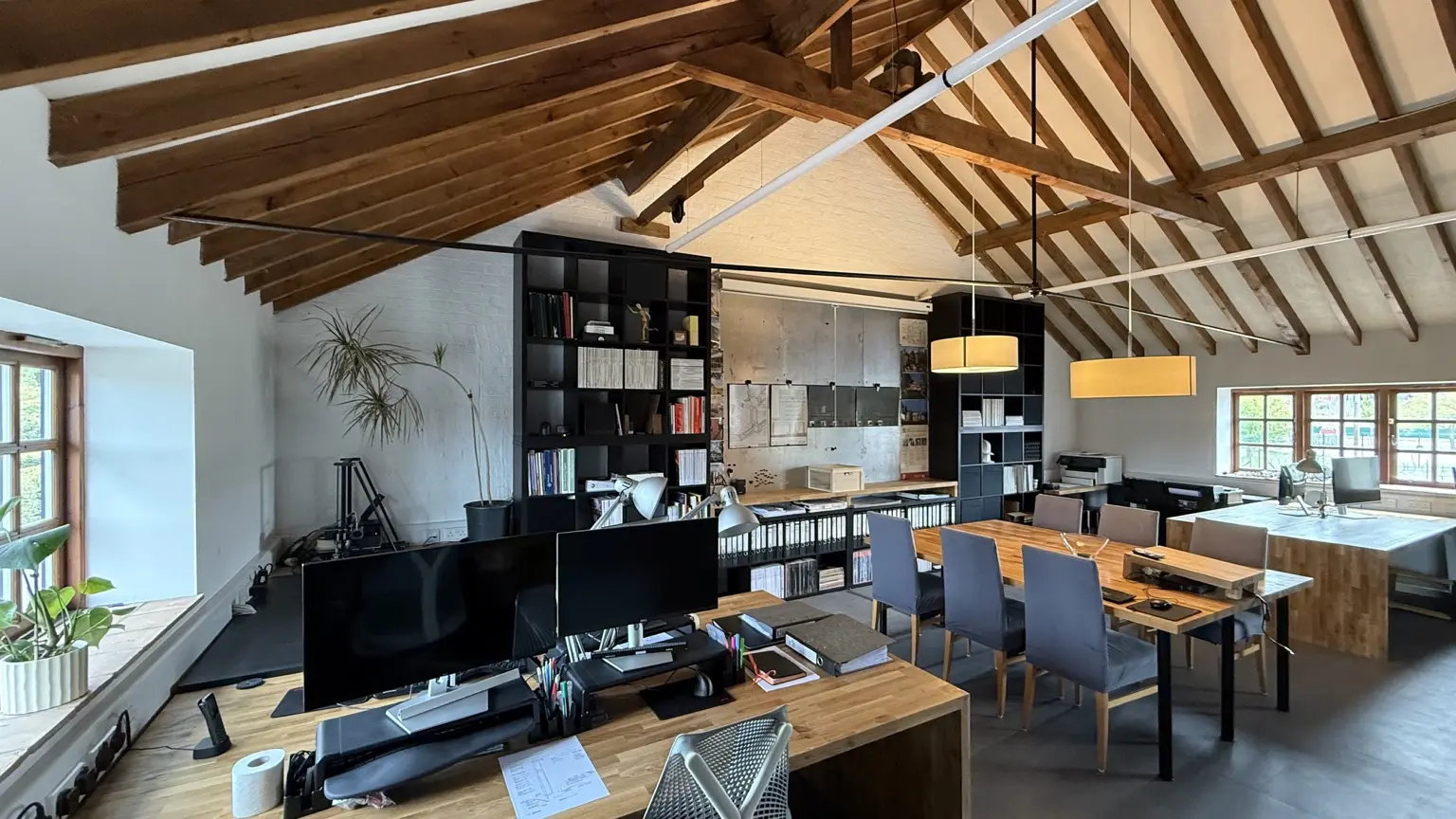 Exedra Architects studio beneath an exposed timber roof