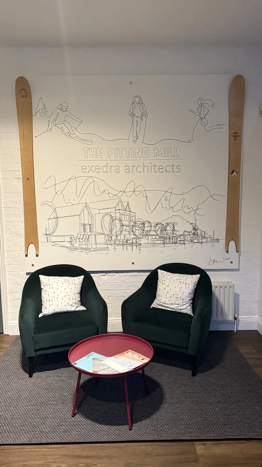 Informal studio seating beside an architectural wall drawing