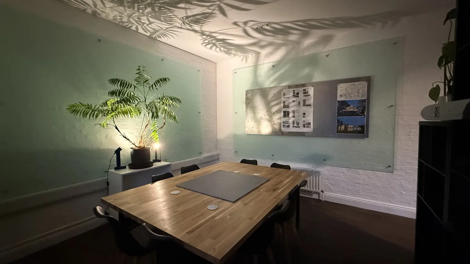 Exedra meeting room with oak table and project display wall
